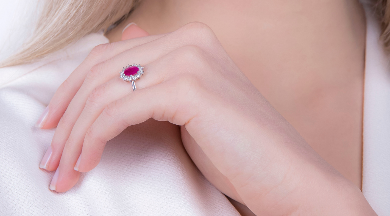 white gold ring with ruby and diamonds on hand