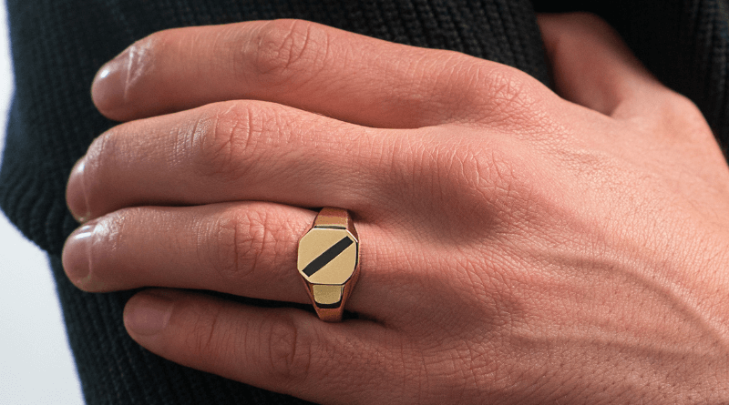 yellow gold ring stamper on man hand