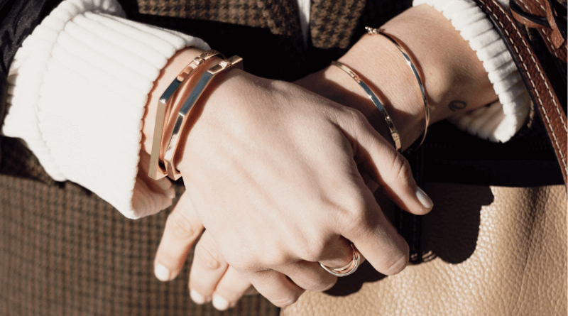 gold bracelets on woman hands
