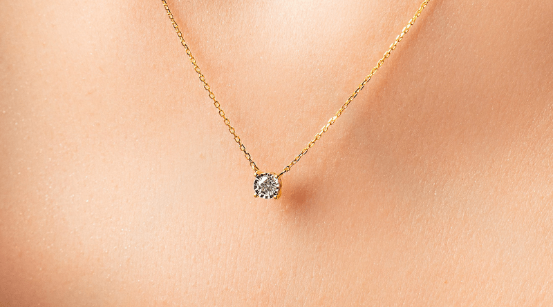 gold necklace with diamond on woman neck