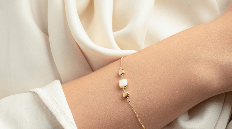 gold jewelry bracelet on white blouse