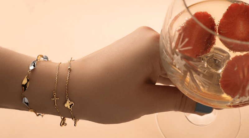 gold bracelets on woman hand