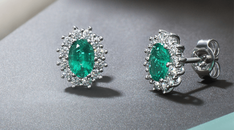 white gold oval earrings with emeralds and diamond