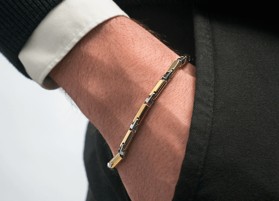 man in elegant clothes wearing gold bracelet