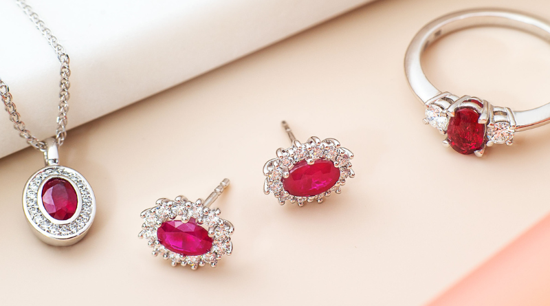 diamond jewelry on blush background with rubies