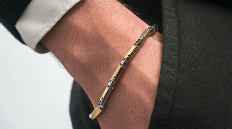 gold bracelet on man hand in pocket