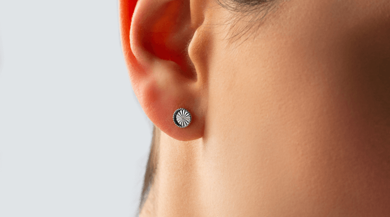 white gold earrings small rounds on woman ear
