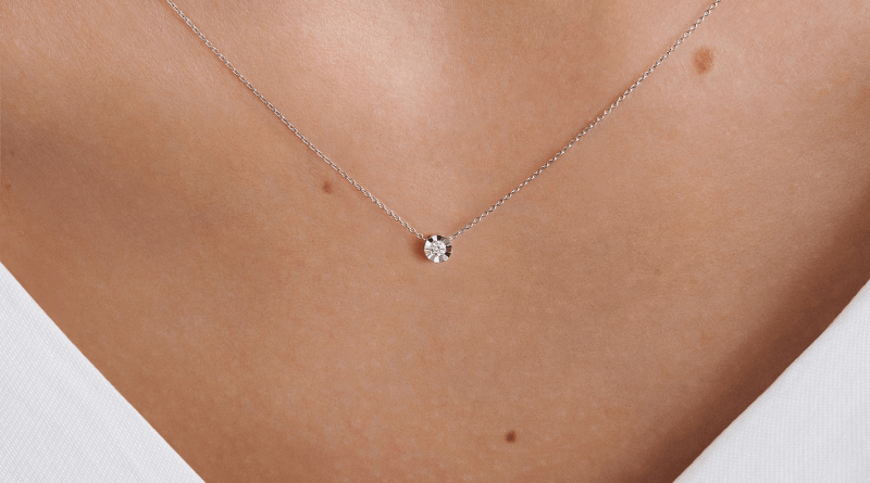 white gold necklace with diamond illusion around it on womans neck