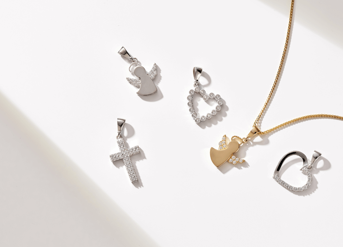 white gold pendant of angel motif on white background
