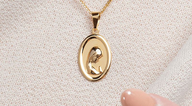 saint mary modern gold pendant on white crochet background