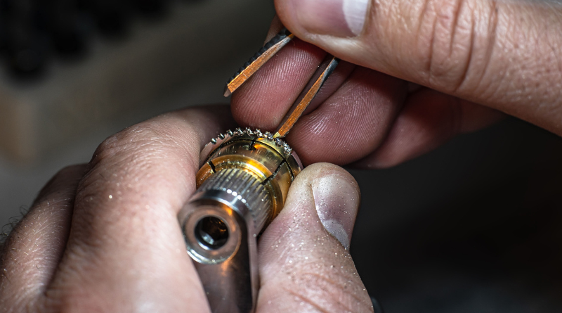 jeweler making gold ring with diamonds