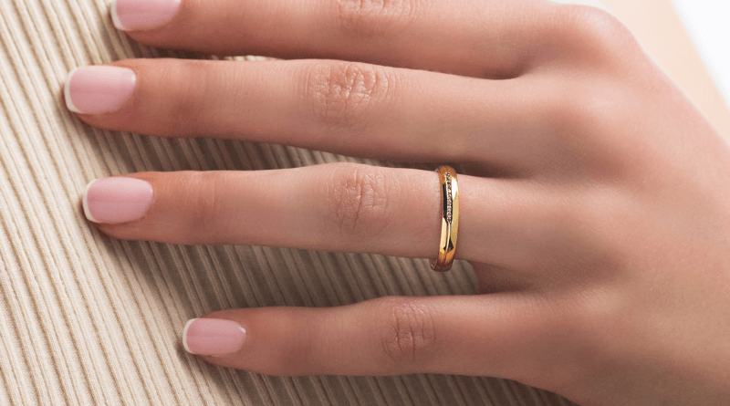 gold wedding ring band on woman hand