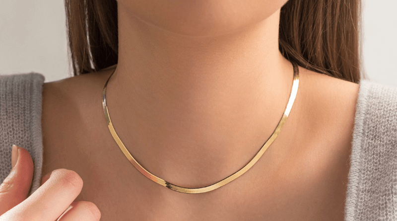 gold statement necklace on womans neck