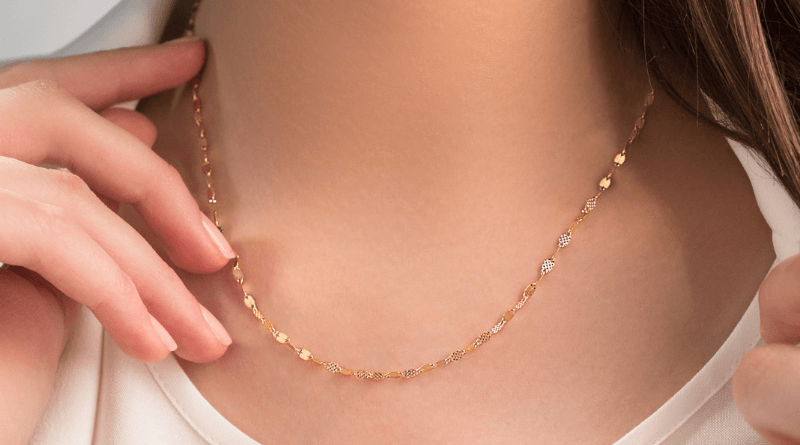 gold necklace chain with on womans neck