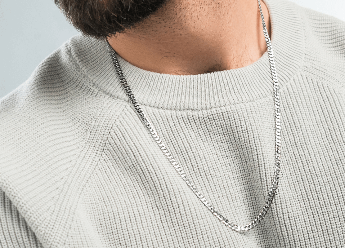 young man wearing grey sweater and modern gold chain